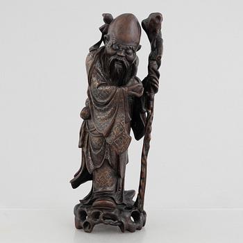A Chinese wooden figure of 'Shoulao' with silver inlays, 20th century.