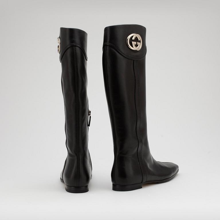 GUCCI, a pair of black leather boots.