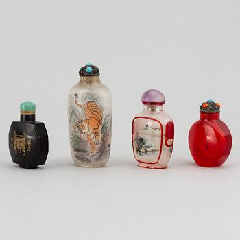 Four Chinese snuff bottles in glass and stone, 20th century.