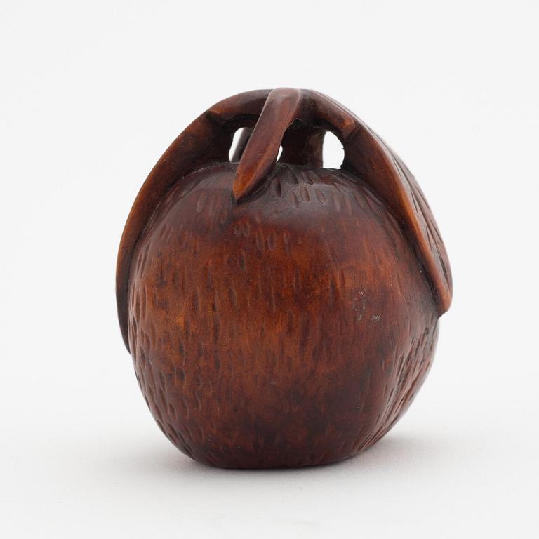 A Japanese carved corozo nut bird feeder, second half of the 19th Century.