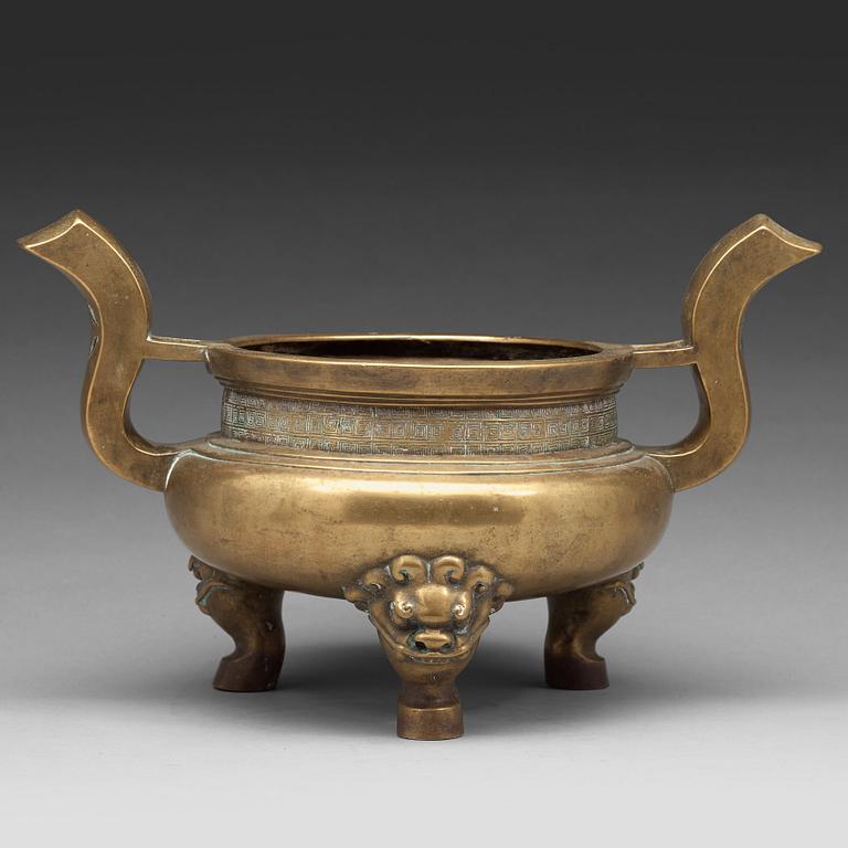 A large brass tripod censer, Qing dynasty (1644-1912).