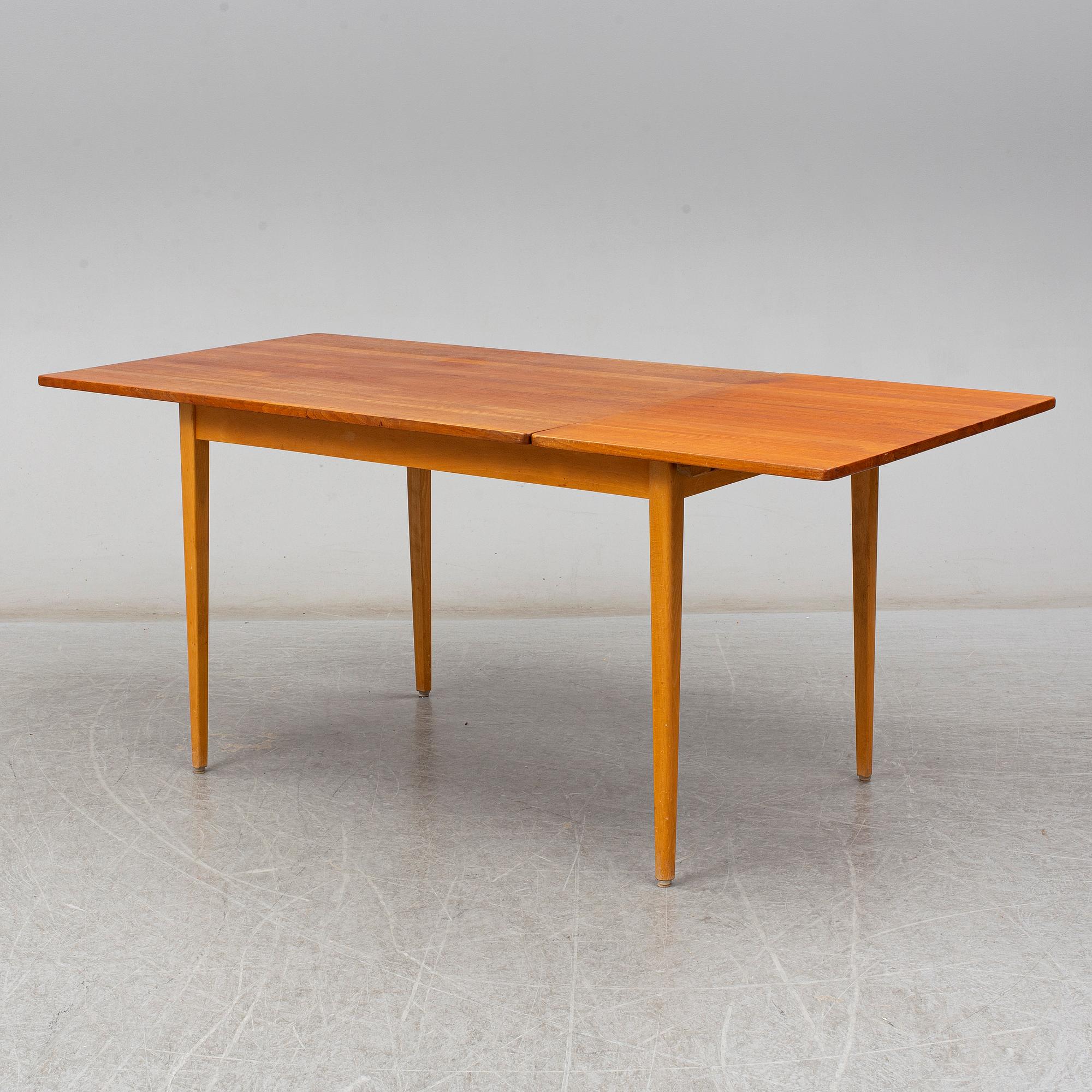 A 1960s teak veneered dining table.