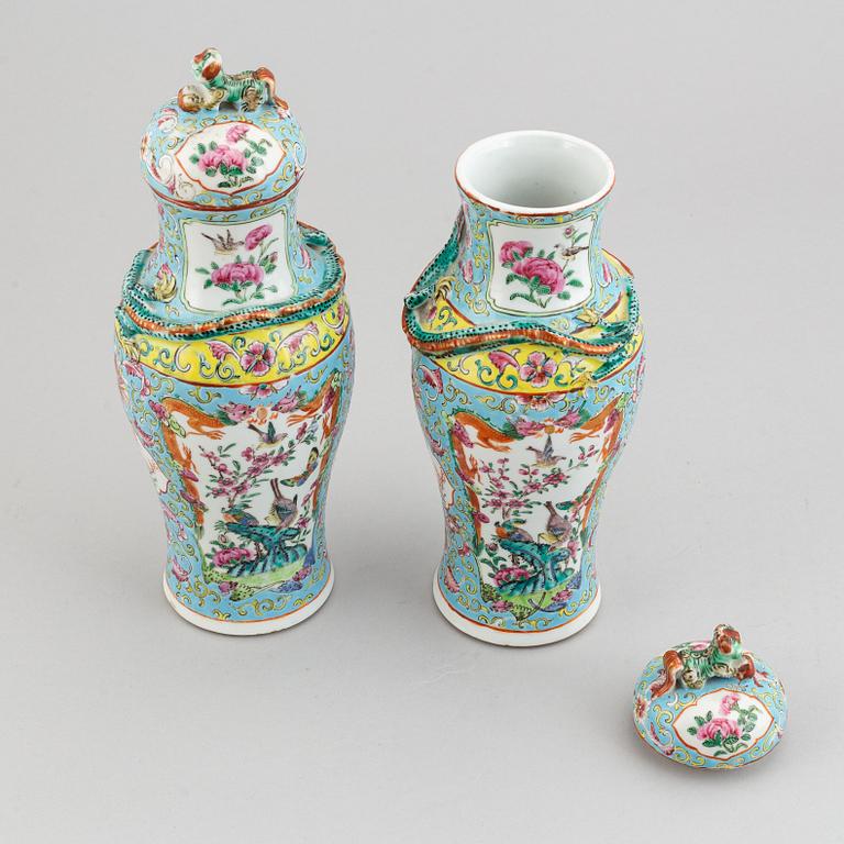A pair of famille rose canton porcelain vases with covers, Qing dynasty, late 19th century.