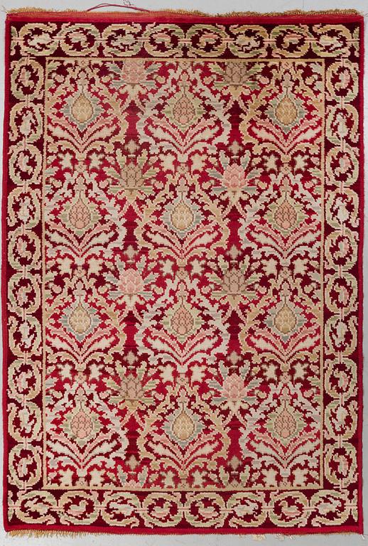 A RUG, a semi-antique Spanish, ca 239,5 x 167,5 cm (as well as ca 2 cm flat weave at the ends),