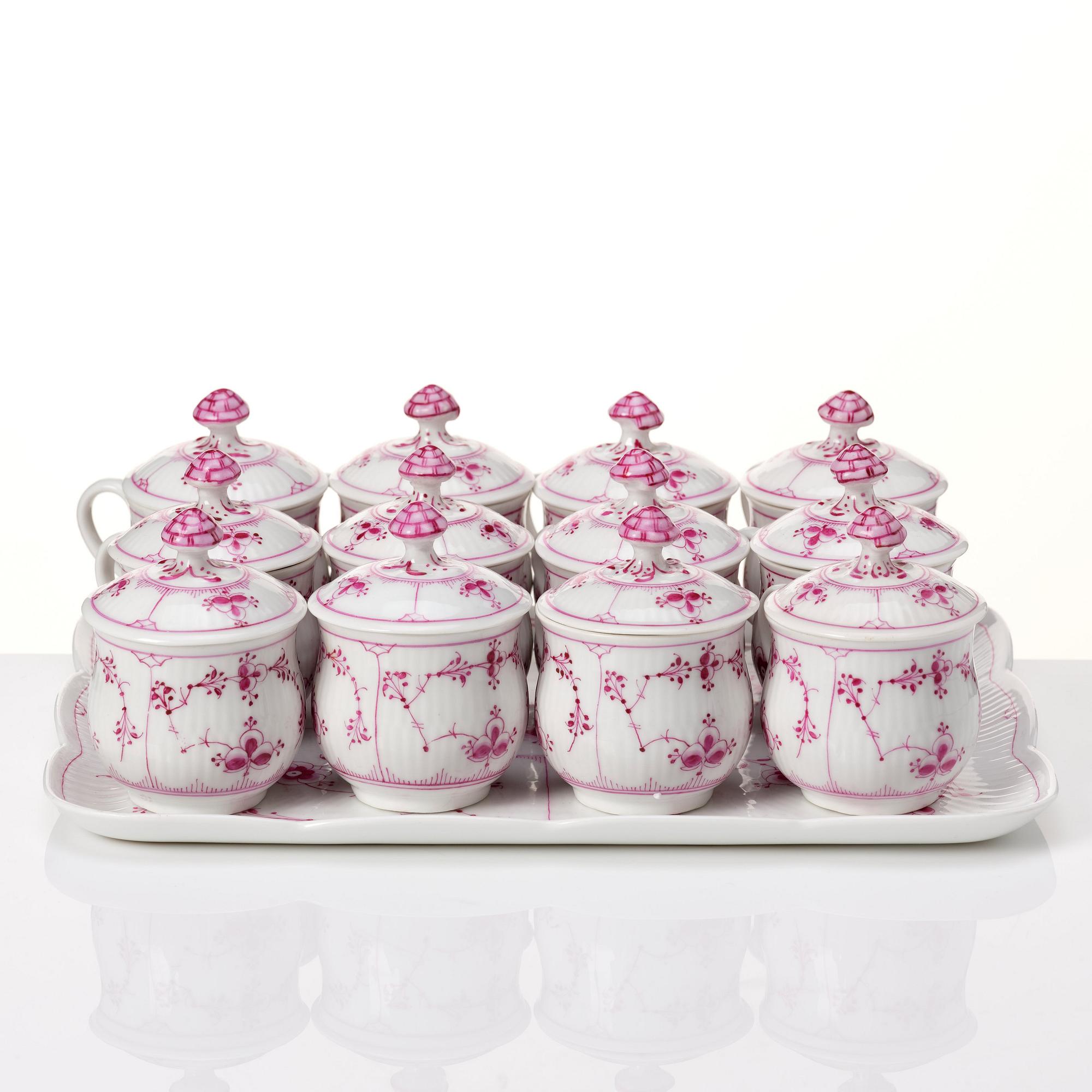 A set of 12 Royal Copenhagen Ruby Red Musselmaalet custard cups with a tray, Denmark, circa 1900-1923.