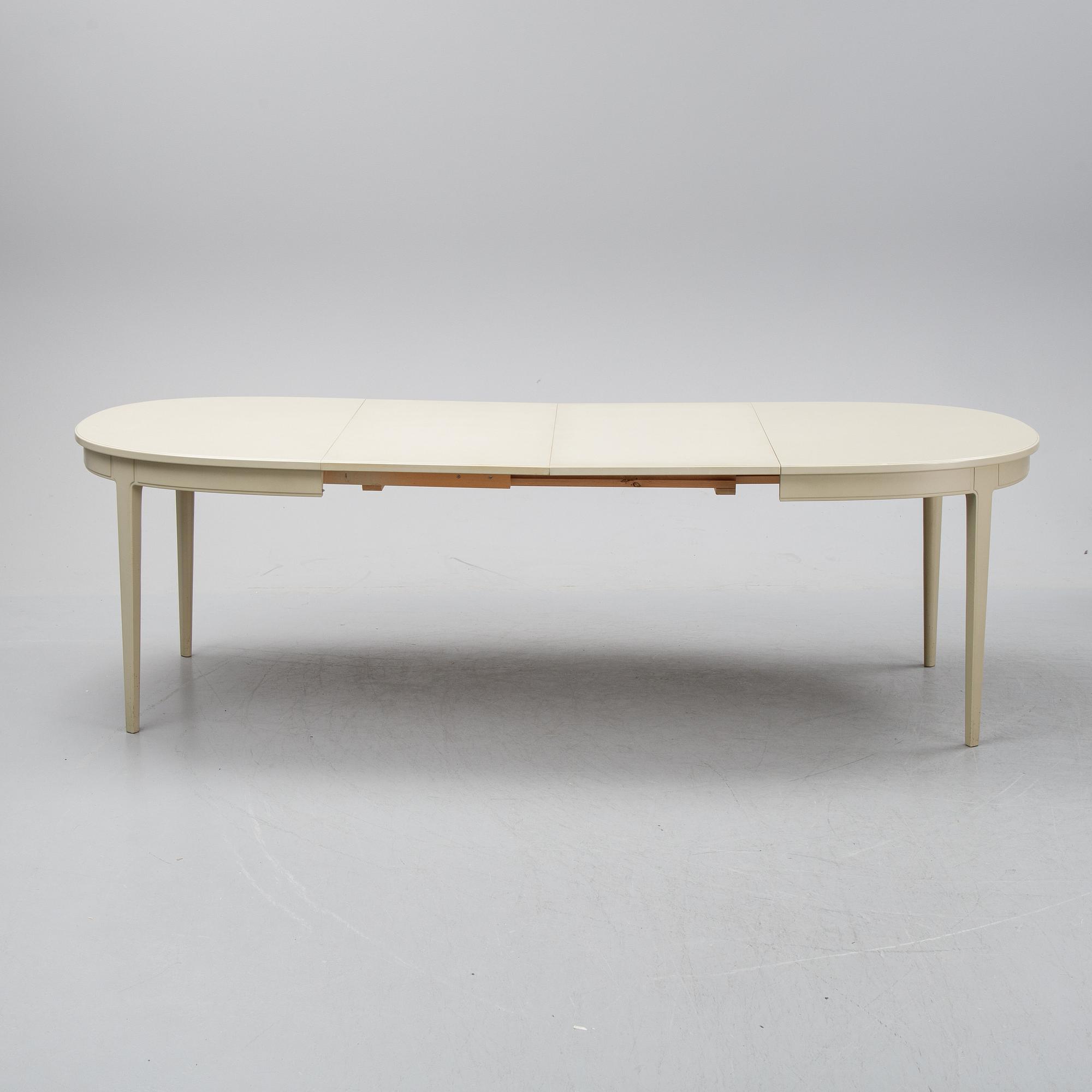 A dining table with six chairs by Carl Malmsten, second half of the 20th Century.