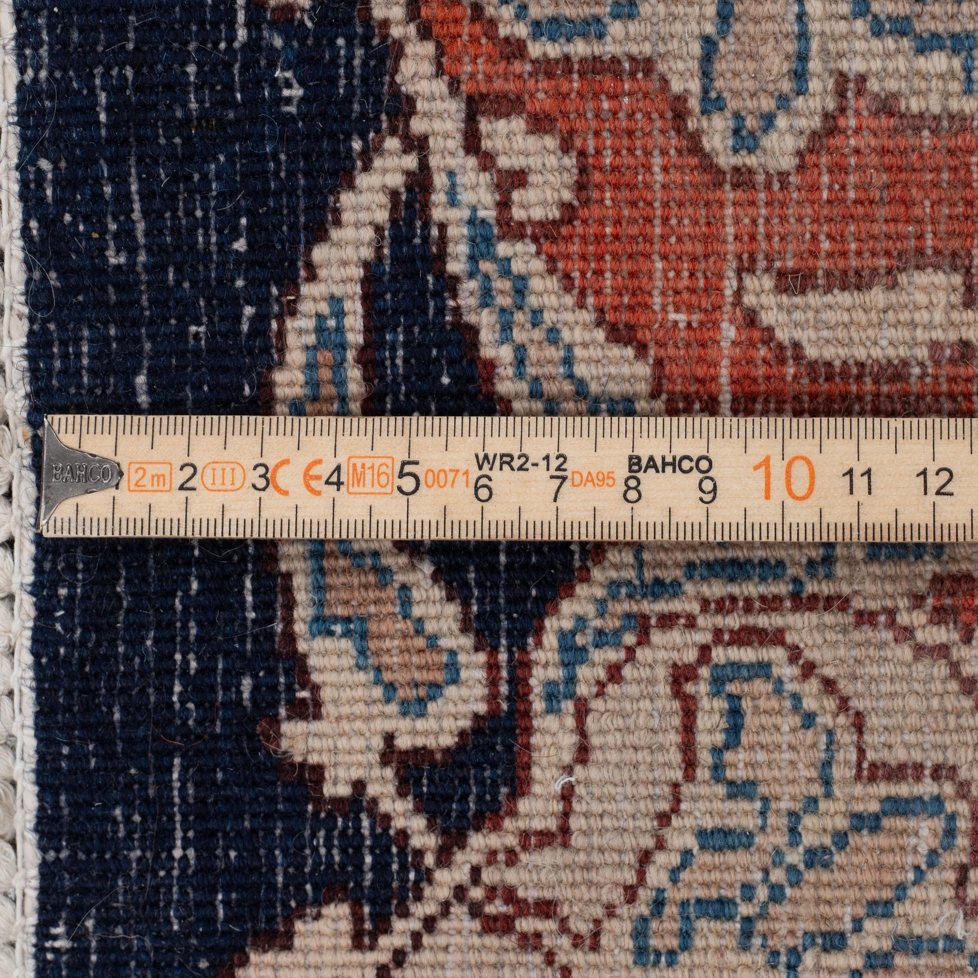 An oriental carpet, circa 390 x 302 cm.