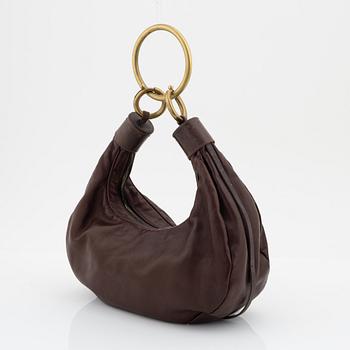 Chloé, a brown leather and brass bag.
