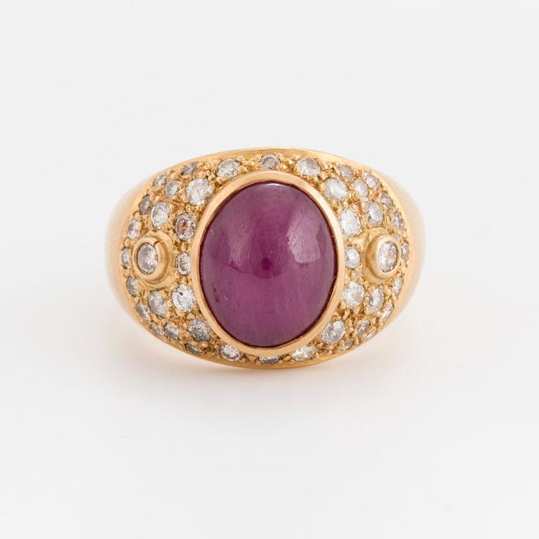 A cabochon cut opaque ruby and brilliant cut diamond ring.