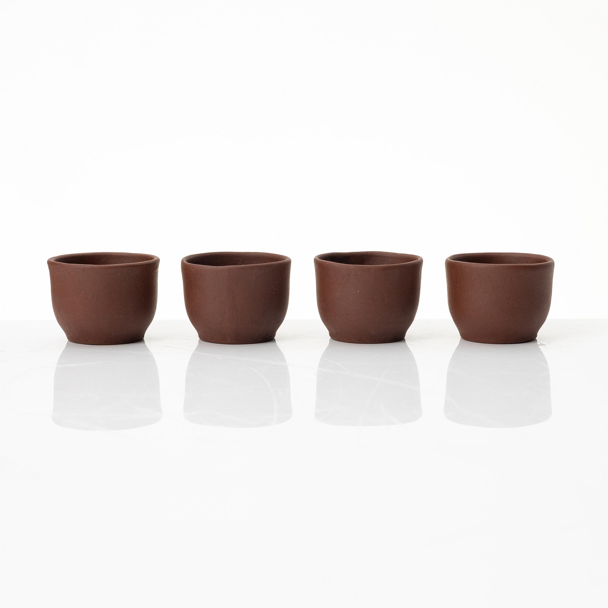 Wu Quan Xiang, A Chinese yixing teapot and a bowl with sieve and four cups, 1980s.