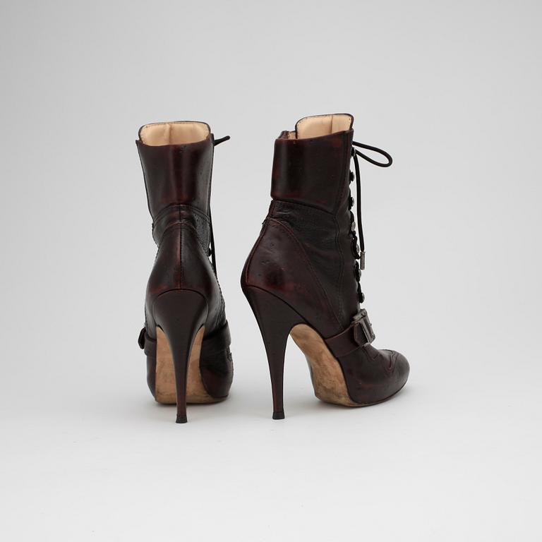 JOHN GALLIANO, a pair of brown leather boots.