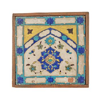 342. A 'cuerda seca' pottery tile, c. 39 x 40 cm (with mounting 44 x 44 cm), Persia (Iran), the Qajar dynasty (1789–1925).