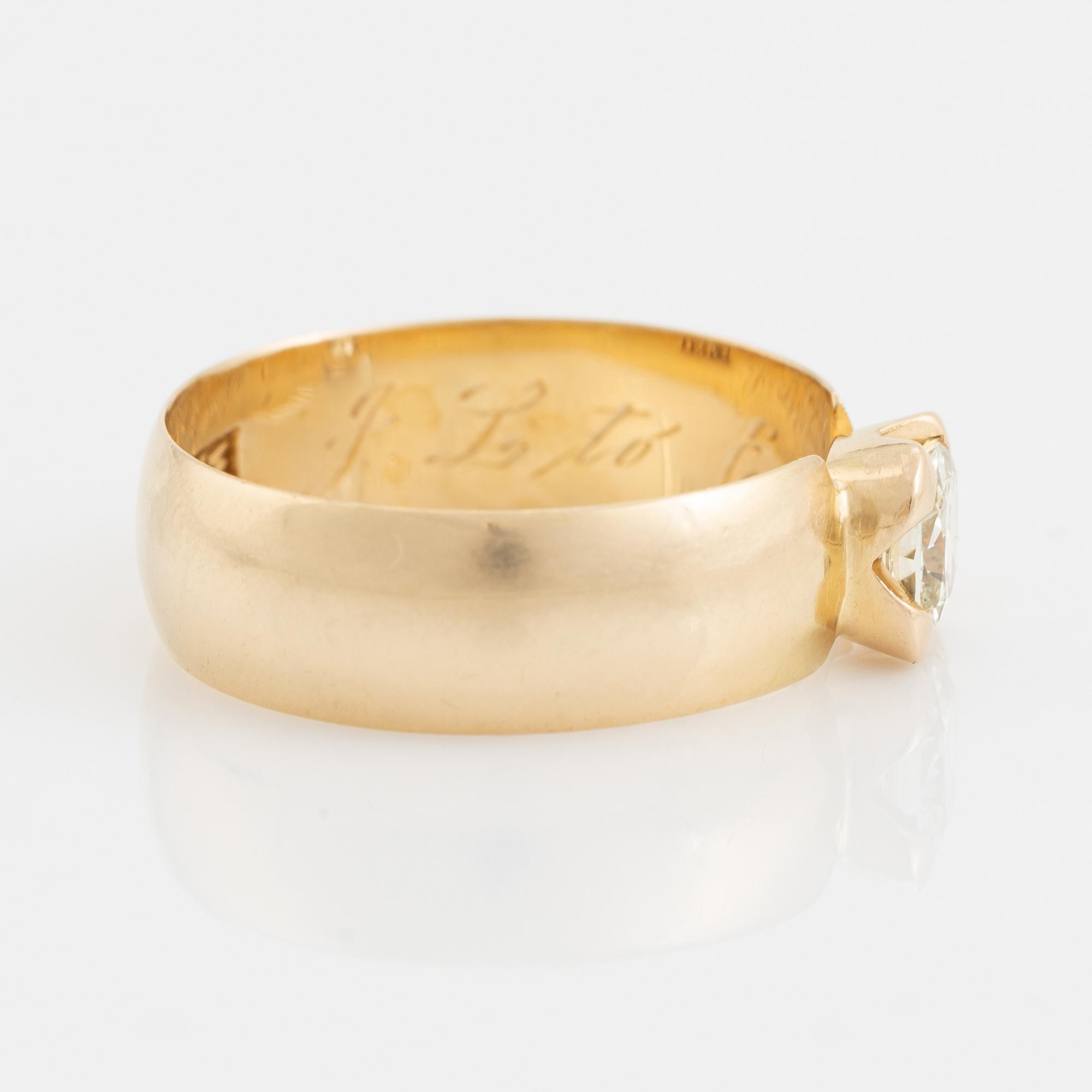 An 18K gold ring set with a radiant-cut diamond.