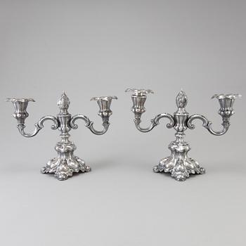 A pair of Swedish Rococo style silver candelabras from C G Hallberg in Stockholm 1955 and 1959.