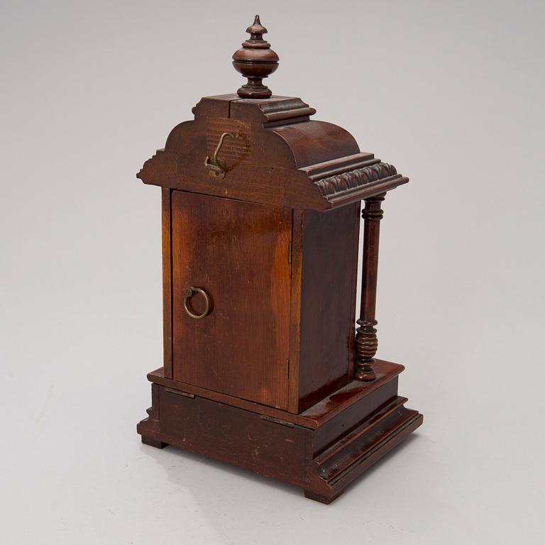 An early 20th century German Junghans table clock with music box.