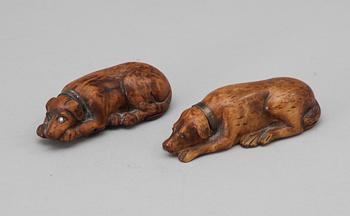 701. Two 19th - 20th century birch snuffboxes in the shape of lying dogs.