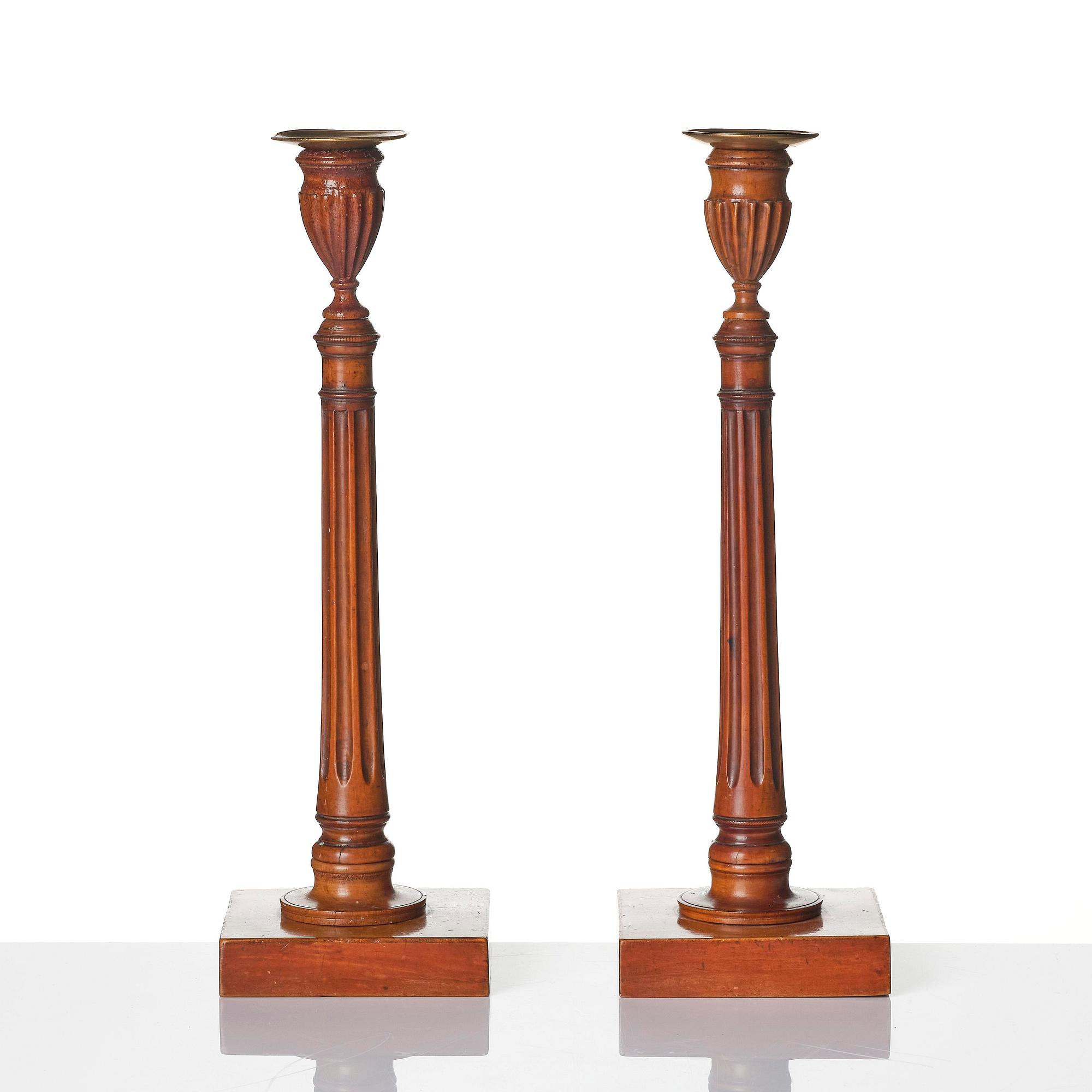 A pair of George III mahogany candlesticks, circa 1800.