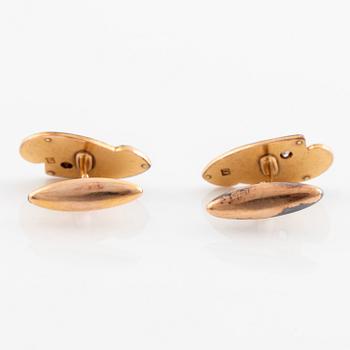 A pair of 14K gold cufflinks set with old-cut diamonds.