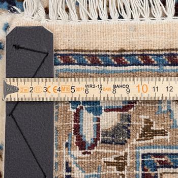 An Oriental carpet, approx. 354 x 243 cm.