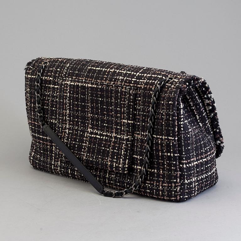 A tweed bag "Classic flip bag XL" by Chanel from 2016-2017.