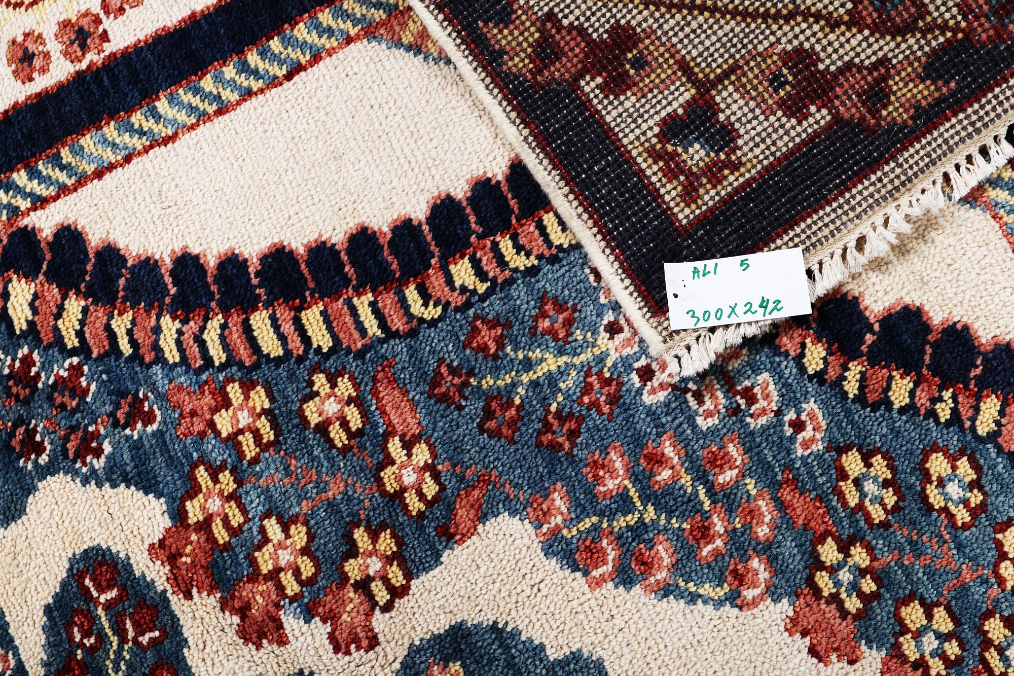 An oriental carpet with Mamluk design, c. 300 x 242 cm.