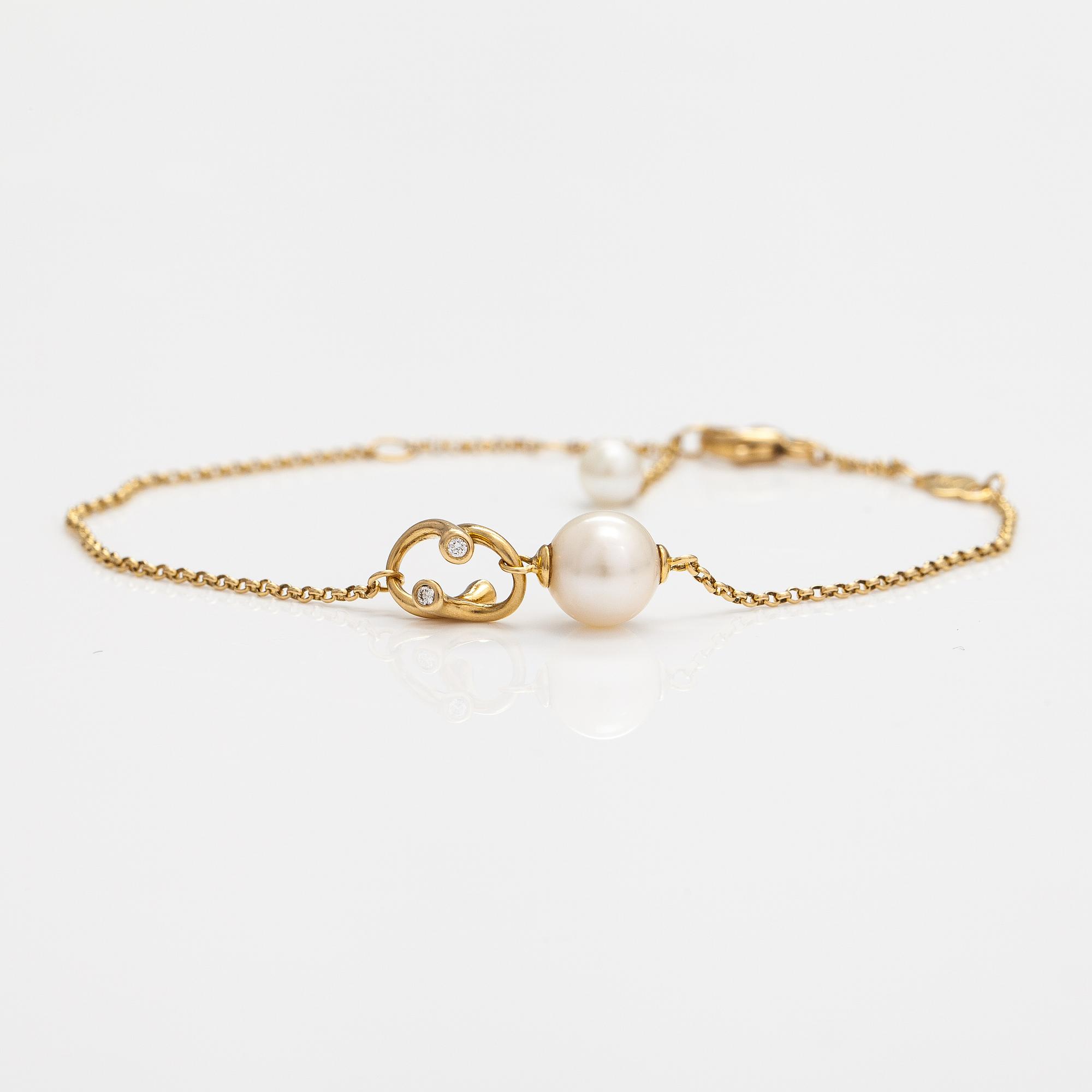 Georg Jensen, An 18K gold bracelet "Magic" with a cultured pearl and diamonds ca. 0.048 ct in total, Denmark.