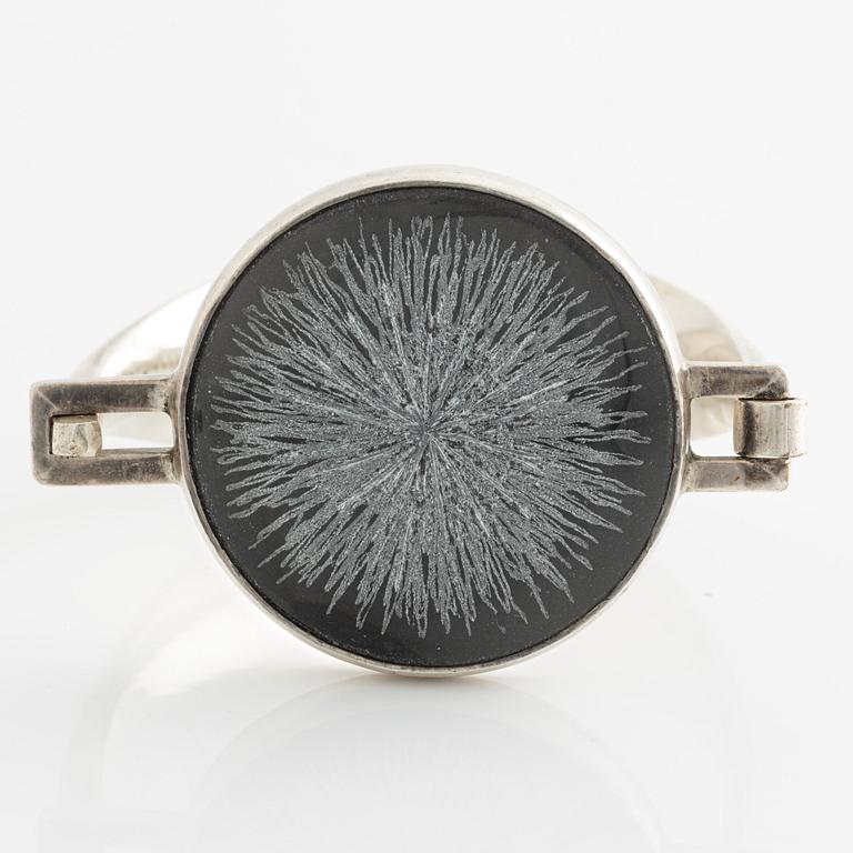 Bangle, silver with inset stone/flower.