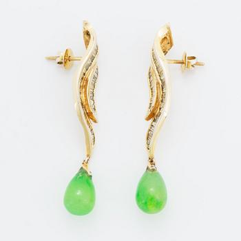Baguette cut diamond and green stone earrings.