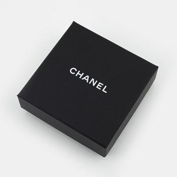 Chanel, a silvermetal, rhinestone and crystal brooch, 2019.