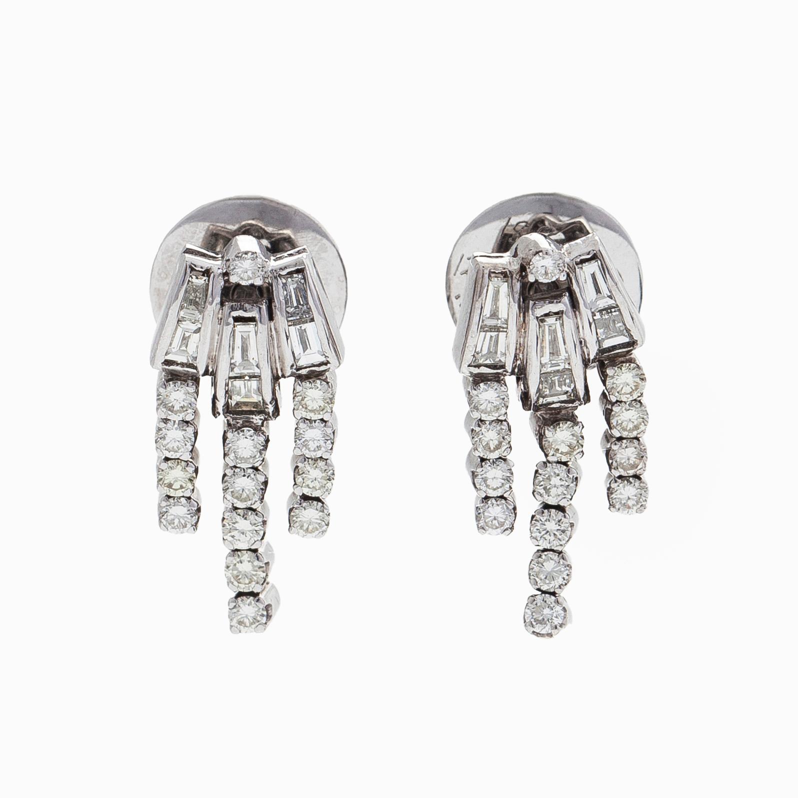 A pair of 18K white gold earrings set with baguette-cut and brilliant-cut diamonds.
