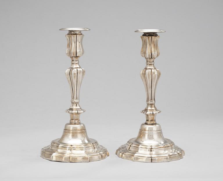 A pair of French 18th century silvered brass candlesticks.