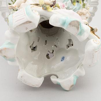 A pair of porcelain rococo style candelabra and a centerpiece bowl, Plaue, Germany, first half of the 20th century.