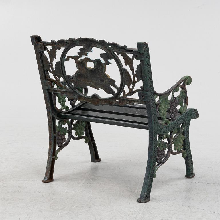 A children's cast iron garden sofa and armchair, mid 20th century.