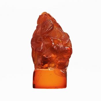 An amber sculpturein the shape of a fawn and a bird amongst pine trees, Qing dynasty (1644-1912).