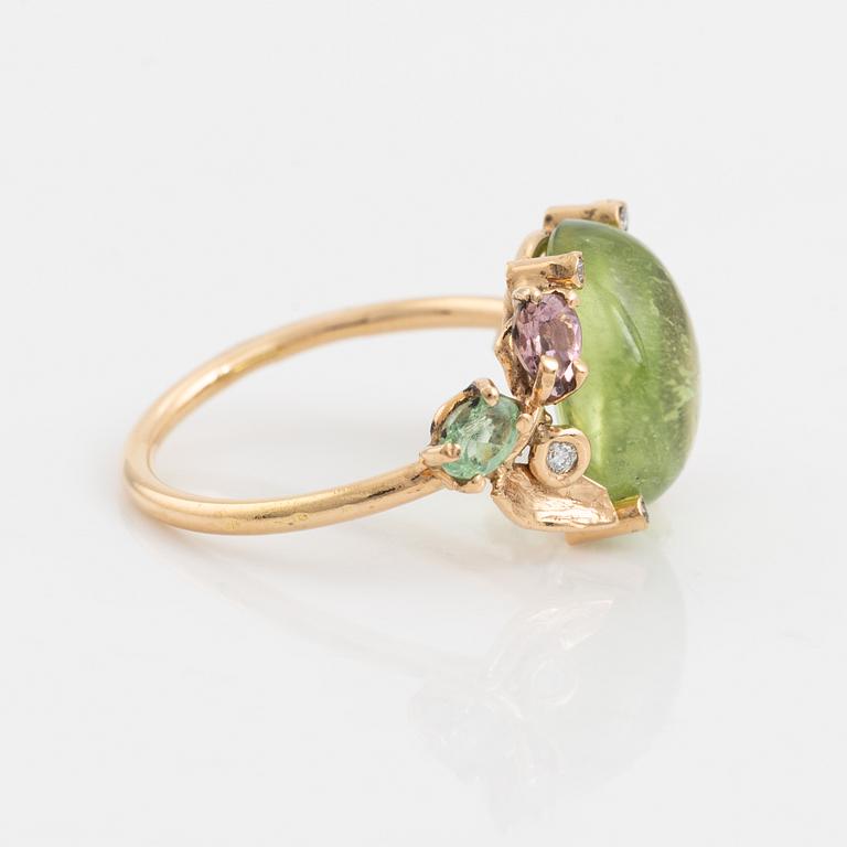 Ring with cabochon-cut peridot, tourmaline, and small diamonds.