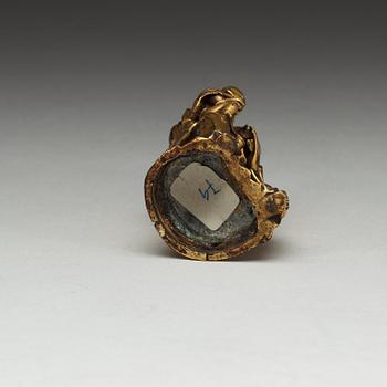 A seated gilt bronze figure of Guanyin with a small boy, Qing dynasty, 18th Century.