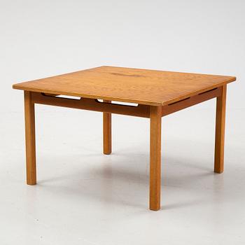 An oak coffee table with a later travertine top.