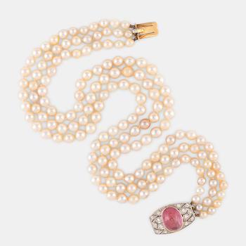 A three strand cultured pearl necklace.