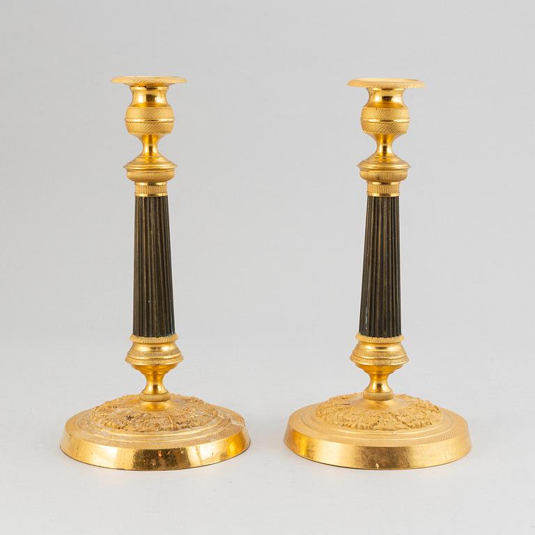 A pair of French Empire candlesticks.