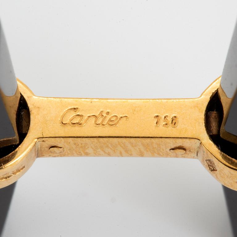 A pair of Cartier cufflinks in 18K gold and onyx.