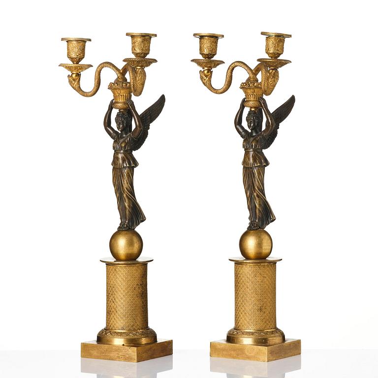 A pair of gilt and patinated bronze Empire-style two branch candelabra, later part 18th century.