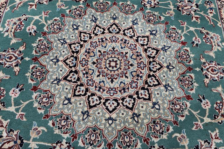 A Nain carpet, part silk, 9 laa, c. 300 x 201 cm.