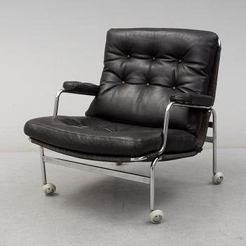 BRUNO MATHSSON, a "Karin" black leather easy chair.