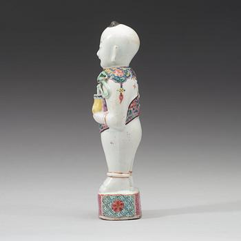 A famille rose figure of a boy, Qing dynasty, 18th Century.