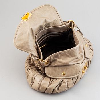 Miu Miu, a light leather handbag.