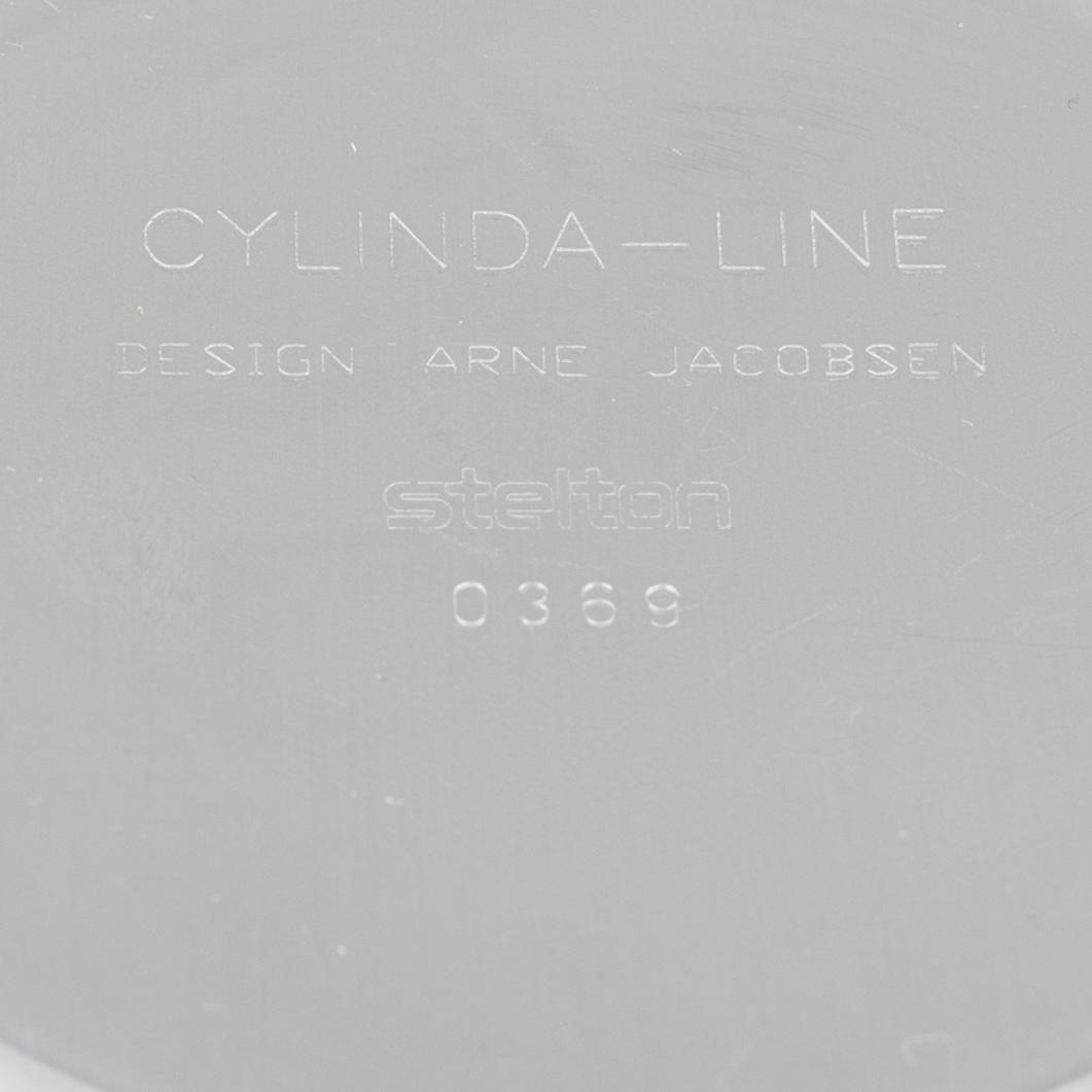 Arne Jacobsen, a 100-year jubilee "Cylinda" stainless steel tea set and a book, Stelton, Denmark, 2002.