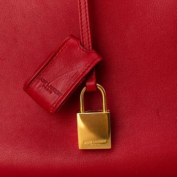 Saint Laurent, a red leather 'Sac du Jour Small' bag.