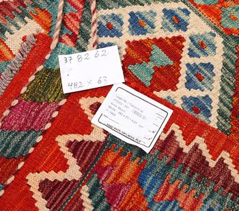 A Kilim carpet, c. 482 x 63 cm.