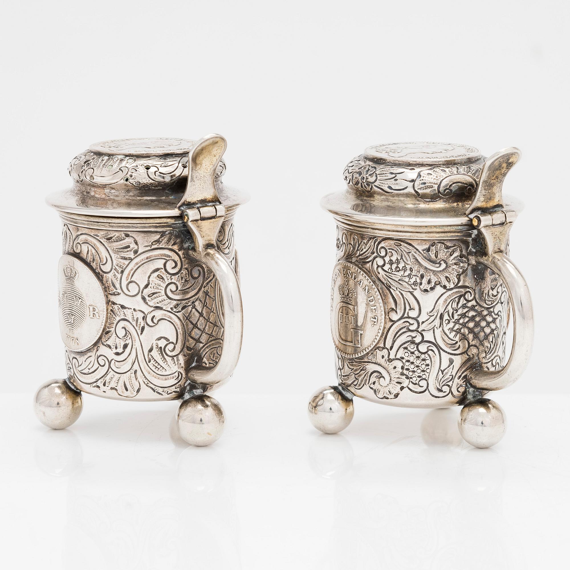 A pair of silver salt and mustard tankard,  C.G. Hallberg, Stockholm 1911 and 1914.