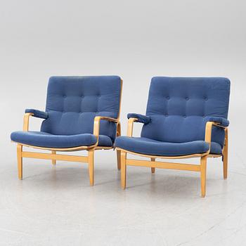 Bruno Mathsson, a pair of armchairs with ottomans, 'Ingrid', Dux, second half of the 20th century.